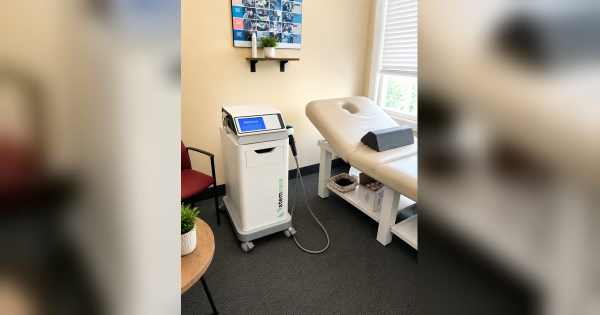 StemWave acoustic wave therapy unit and handpiece beside a treatment table at Total Wellness Chiropractic in Bowie, MD